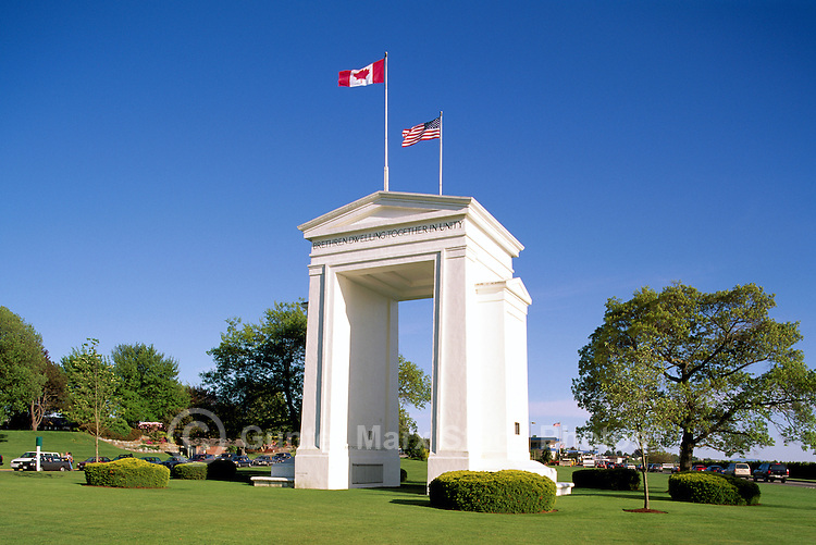 Peach Arch (Canadian Side) at Canada - United States Border, Peace Arch Provincial Park, Surrey (near White Rock), BC, British Columbia, Canada - Peace Arch International Border Crossing / Douglas Border Crossing. Beyond Monument (built 1921) is Peace Arch State Park, Blaine, WA, Washington, USA