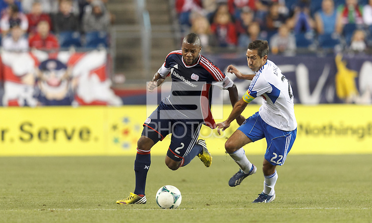 New England Revolution defender Andrew Farrell (2) works to clear ball as Montreal Impact midfielder Davy Arnaud (22) pressures. In a Major League Soccer (MLS) match, Montreal Impact (white/blue) defeated the New England Revolution (dark blue), 4-2, at Gillette Stadium on September 8, 2013.