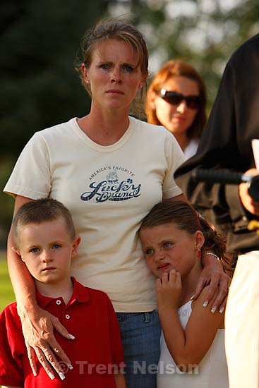 Huntington - Family members of miners missing in the Crandall Canyon coal mine stand with spokesman Sonny Olsen as he reads their statement to the media in the Huntington City Park. The family members wished to remain unidentified..; 8.23.2007