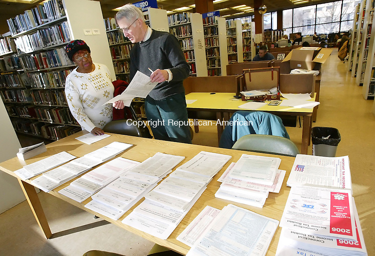 WATERBURY, CT, 03/07/07- 030707BZ06- John Staver, of Watertown, of Volunteers Income Tax Assistance (VITA), helps Gladys Passmore, of Waterbury, prepare her income tax returns at the Silas Bronson Library in Waterbury Wednesday afternoon. According to the IRS Website, VITA volunteers are certified to help prepare basic tax returns in communities across the country. The VITA program at the Silas Bronson Library is held between 3 p.m. and 7 p.m. on Wednesday's. Staver said an average of 25 people show up each week for the free help even though he is only able to service 10 to 12 daily. "One day I had 37 people lined up," he said. In addition to VITA the AARP also offers free tax preparation at the Library on Tuesday's and Wednesday's between the hours of 10 a.m. and 1 p.m. Both programs continue through April 11, 2007.<br />
Jamison C. Bazinet Republican-American