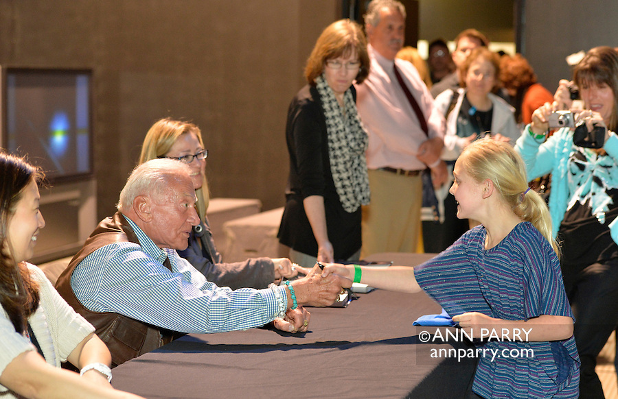 May 11, 2013 - Garden City, New York U.S. - Astronaut BUZZ ALDRIN, the second person to walk on the moon, shakes the hand of a young girl at the book signing for his new books "Mission to Mars" and the illustrated history of space exploration "Look to the Stars." After Aldrin, the NASA astronaut engineer of Apollo 11 in 1969, gave a Sold Out lecture, people who bought his books at the museum book store could attend the book signing at the LEM room of the Cradle of Aviation Museum.