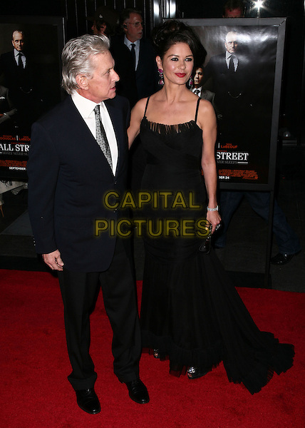 MICHAEL DOUGLAS & CATHERINE ZETA JONES.Premiere of 'Wall Street: Money Never Sleeps' at the Ziegfeld Theatre on September 20, 2010 in New York City, New York, NY, USA..September 20th, 2010.full length suit jacket black white dress white shirt married husband wife navy blue maxi profile .CAP/ADM/PZ.©Paul Zimmerman/AdMedia/Capital Pictures.