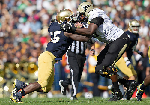 September 08, 2012: Notre Dame outside linebacker Prince Shembo (55) and Purdue offensive tackle Justin Kitchens (51) battle at the line of scrimmage during NCAA Football game action between the Notre Dame Fighting Irish and the Purdue Boilermakers at Notre Dame Stadium in South Bend, Indiana. Notre Dame defeated Purdue 20-17.