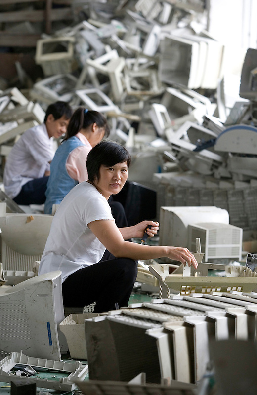 A migrant worker processes plastic computer screen casings in a workshop specialising in recycling electronic trash in Panyu, China. Each year, between 20 and 50 million tons of electronic waste is generated globally. Most of it winds up in the developing world. Some of the most popular destinations for dumping computer hardware include China, India, and Nigeria. It can be 10 times cheaper for a ìrecyclerî to ship waste to China than to dispose of it properly at home. With the market for e-waste expected to top $11 billion by 2009, itís lucrative to dump on the developing world.