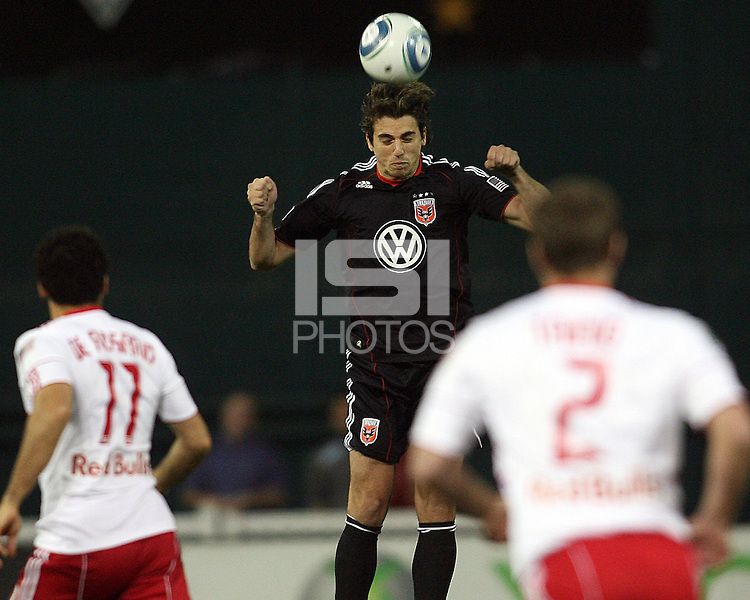Dejan Jakevic (5) of D.C. United heads over Dwayne De Rosario (11) of the New York Red Bulls during an MLS match at RFK Stadium, in Washington D.C. on April 21 2011. Red Bulls won 4-0.