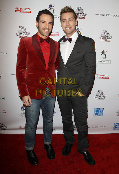 George Kotsiopoulos & Lance Bass.2nd Annual Hollywood Rush Benefiting The Baby Dragon Fund held at The Wilshire Ebell Theatre, Los Angeles, California, USA..February 19th, 2012.full length red velvet jacket jeans denim tuxedo white shirt.CAP/ADM/KB.©Kevan Brooks/AdMedia/Capital Pictures.