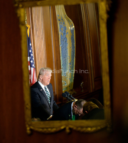United States President Donald J. Trump is seen in a mirror as he speaks during the Friends of Ireland Luncheon at the U.S Capitol on March 16, 2017 in Washington, DC. <br />
Credit: Olivier Douliery / Pool via CNP /MediaPunch