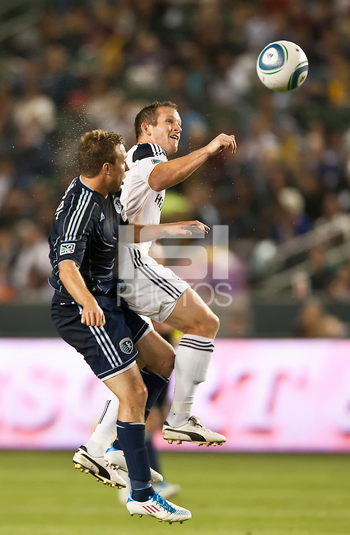 CARSON, CA – May 14, 2011: Sporting KC defender Michael Harrington (2) and LA Galaxy forward Chad Barrett (11) go up high during the match between LA Galaxy and Sporting Kansas City at the Home Depot Center in Carson, California. Final score LA Galaxy 4, Sporting Kansas City 1.
