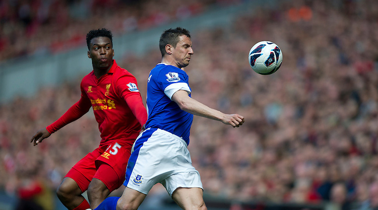 Everton's Phil Jagielka watched by Liverpool's Daniel Sturridge .. - (Photo by Stephen White/CameraSport) - ..Football - Barclays Premiership - Liverpool v Everton - Sunday 5th May 2013 - Anfield - Liverpool..© CameraSport - 43 Linden Ave. Countesthorpe. Leicester. England. LE8 5PG - Tel: +44 (0) 116 277 4147 - admin@camerasport.com - www.camerasport.com