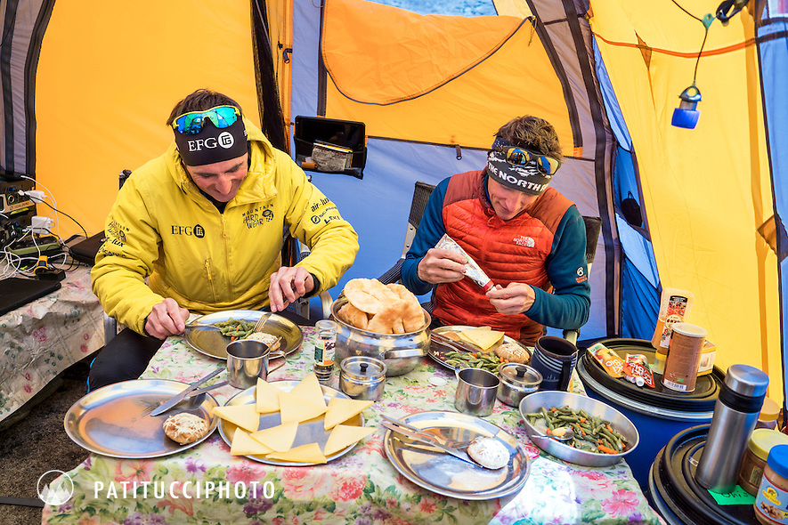 Ueli Steck and David Göttler inside their basecamp tent getting ready to eat during their climbing expedition to the 8000 meter peak Shishapangma, Tibet