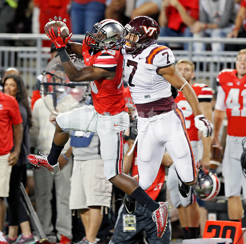 Ohio State Buckeyes cornerback Eli Apple (13) makes an interception against Virginia Tech Hokies tight end Bucky Hodges (7) during the 1st quarter of their game in Ohio Stadium on September 6, 2014. (Dispatch photo by Kyle Robertson)