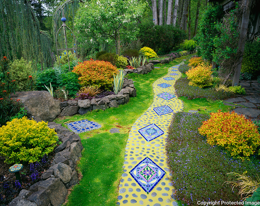 Vashon Island, WA<br />
Whimsical garden of tile artist Clare Dohna featuring snake pathway of moasic tiles and round stones