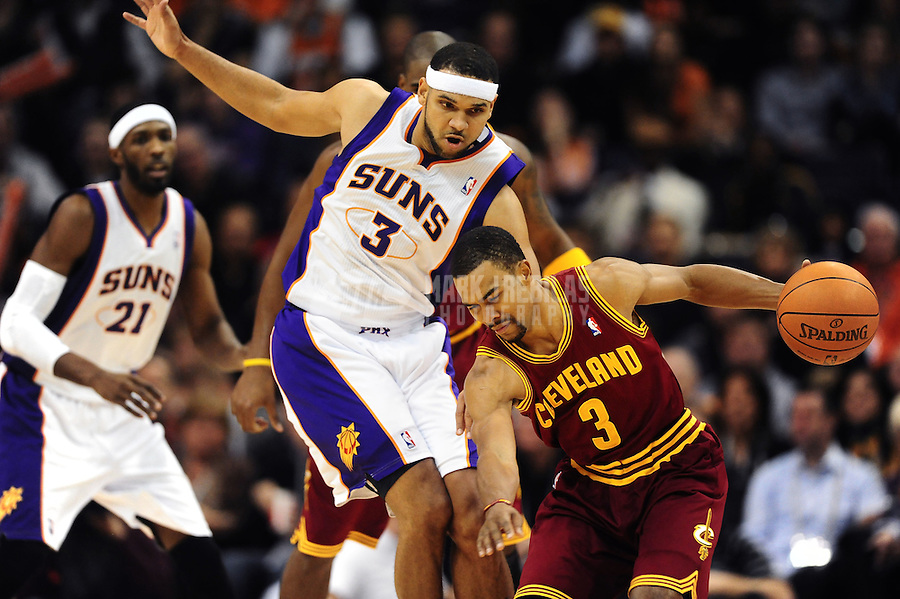 Jan. 12, 2012; Phoenix, AZ, USA; Cleveland Cavaliers guard Ramon Sessions (right) under pressure from Phoenix Suns forward Jared Dudley at the US Airways Center. The Cavaliers defeated the Suns 101-90. Mandatory Credit: Mark J. Rebilas-USA TODAY Sports
