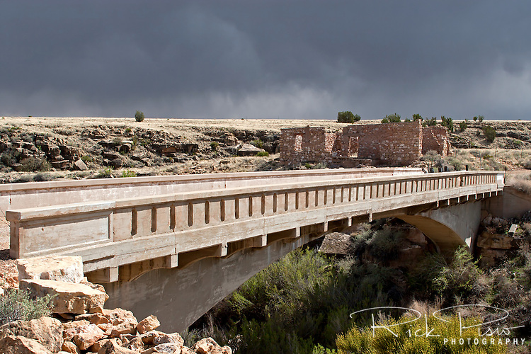 Route 66 Bridge over Diablo Canyon at Two Guns, Arizona, sits abandoned. Two Guns is located in Arizona, east of Flagstaff, on what was formerly Route 66. Two Guns was originally called "Canyon Lodge" when the National Trail Highway moved westward. Later, the National Trail was re-named Route 66, the site's name was changed to Two Guns, because the proprietor of the facilities located there was one Henry E. Miller, who called himself "Two Gun Miller." During the heyday of Route 66, Two Guns became one of the numerous tourist traps along the way, with a gas station, overnighting accommodations, a food emporium, as well as a zoo. Two Guns went into decline with the building of the Interstate.
