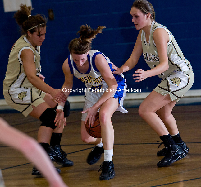 FALLS VILLAGE, CT - 02 FEBRUARY 2009 -020209JT06-<br />
Housatonic's Sarah Godburn loses grip of the ball as she's caught between Thomaston's Morgan Doyle and Brittany Brandt during Monday's game at Housatonic. Housy won.<br />
Josalee Thrift / Republican-American