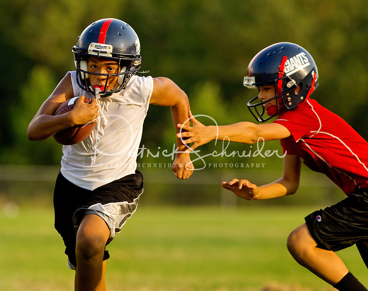 Youth sports photography of boys participating in the Cornelius, NC-based Lake Norman Giants football league, part of the Pop Warner Football and Cheer program. Pop Warner is a non-profit organization focused on teaching leadership, teamwork, discipline and football fundamentals. The Lake Norman Giants league offers five distinct play levels of tackle football. Divisions are determined by age and weight. Players in this series of photos are part of the Jr Midget division.
