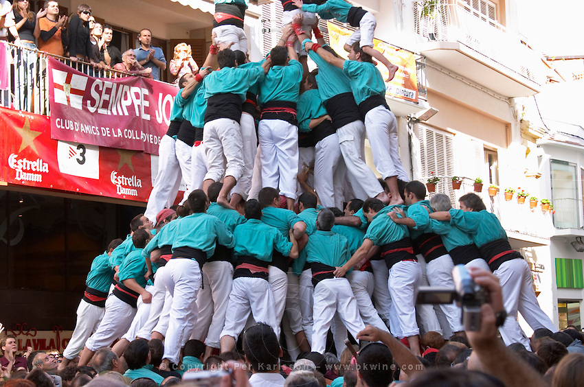 Human tower competition, castellers, Climbing up. Sitges, Catalonia, Spain