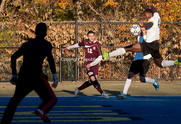 WATERBURY, CT--- -102615JS08---Wilby's Rohan Rhule (4) tries to clear a centering pass by Torrington's Dalton Finello (12) as Wilby goalkeeper Christian Colon looks on during their game Monday at Municipal Stadium in Waterbury. <br />
Jim Shannon Republican-American
