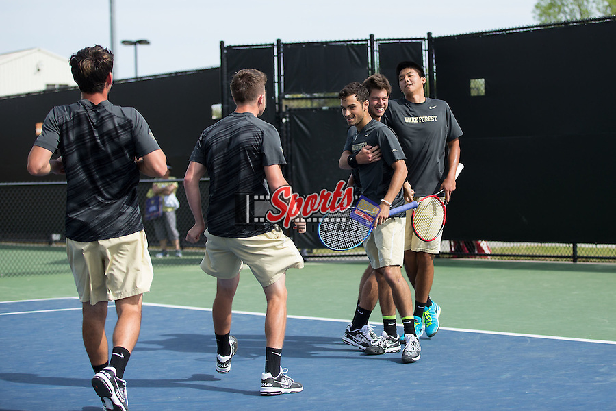 Noah Rubin (second from right) and doubles partner Jon Ho (right) are congratulated by their teammates after clinching the doubles point against the North Carolina Tar Heels at the Wake Forest Tennis Center on April 11, 2015 in Winston-Salem, North Carolina. The Demon Deacons defeated the Tar Heels 4-3. (Brian Westerholt/Sports On Film)