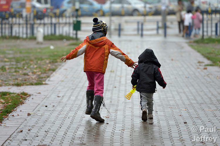 Two refugee children walk in a city park in Belgrade, Serbia. The park has filled with refugees from several countries stopping over on their way to Germany, Sweden, Holland, and elsewhere.