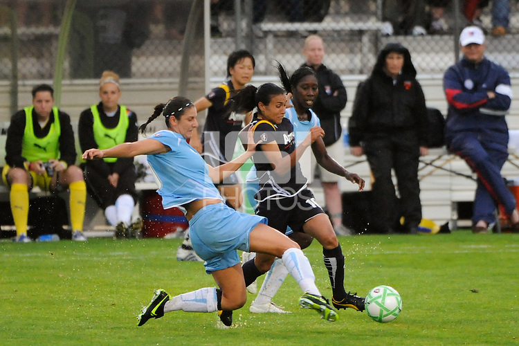 Marta (10) of the Los Angeles Sol is defended by Yael Averbuch (10) and Anita Asante (5) of Sky Blue FC. Sky Blue FC and the Los Angeles Sol played to a 0-0 tie during a Women's Professional Soccer match at Yurcak Field in Piscataway, NJ, on June 13, 2009.