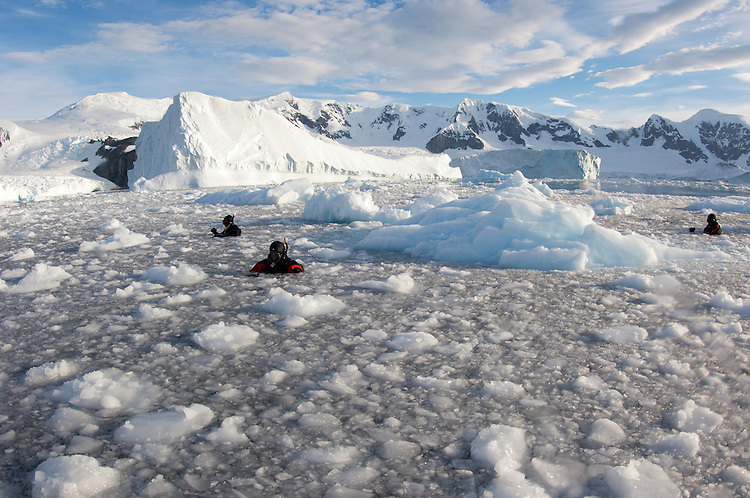 Film makers and, photographers and scientists at work in brash ice behind Danco Island, Antarctica, during the Elysium Expedition