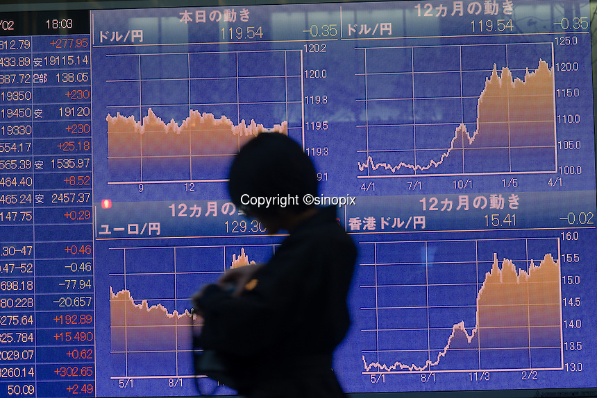 Businessmen pass a board showing the stock values Tokyo, Japan. Japan’s benchmark gauge has climbed 10 percent this year, the best performance among developed Asian stock markets, as buying by the central bank and the nation’s $1.1 trillion pension fund buoyed shares<br />
March-2015