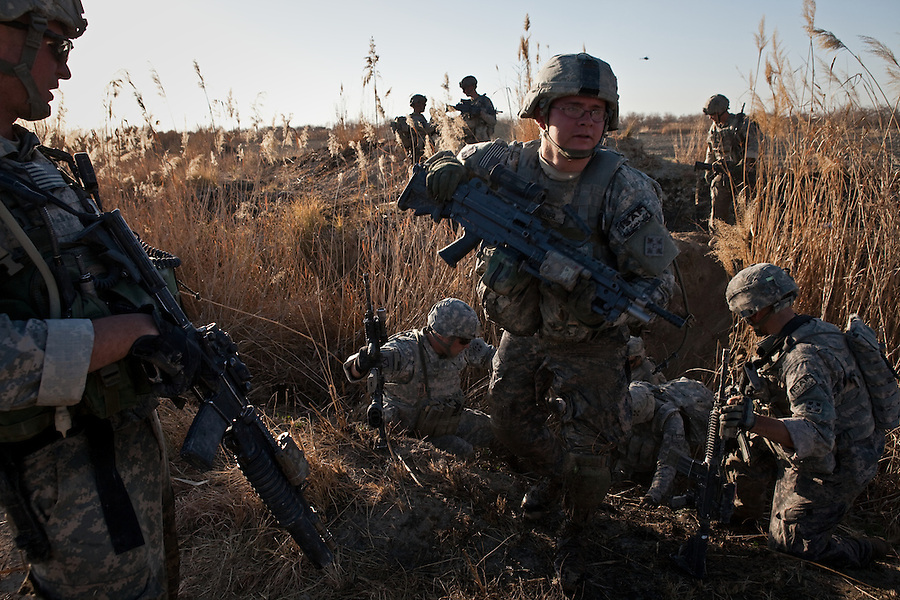 Soldiers with Charlie Co. 1st Battalion 12th Infantry Regiment, 4th Infantry Division negotiate an irrigation ditch in Zhari District, Kandahar, Afghanistan. The violently contested district sits astride the strategically Highway 1 ringroad between Kandahar and Lashkar Gah and is seen by some as the birthplace of the Taliban movement.