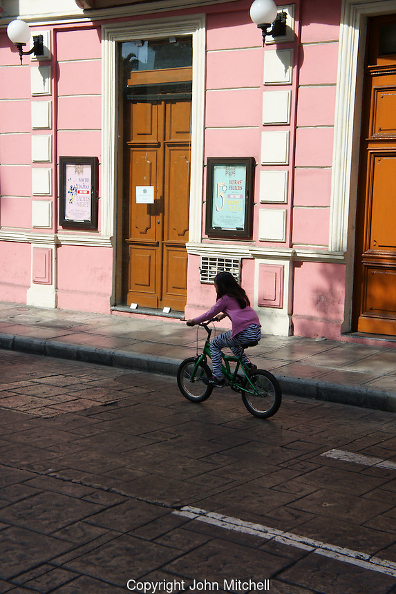 Girl riding a bicycle during Sunday bici ruta on Calle 60 in Merida, Yucatan, Mexico...