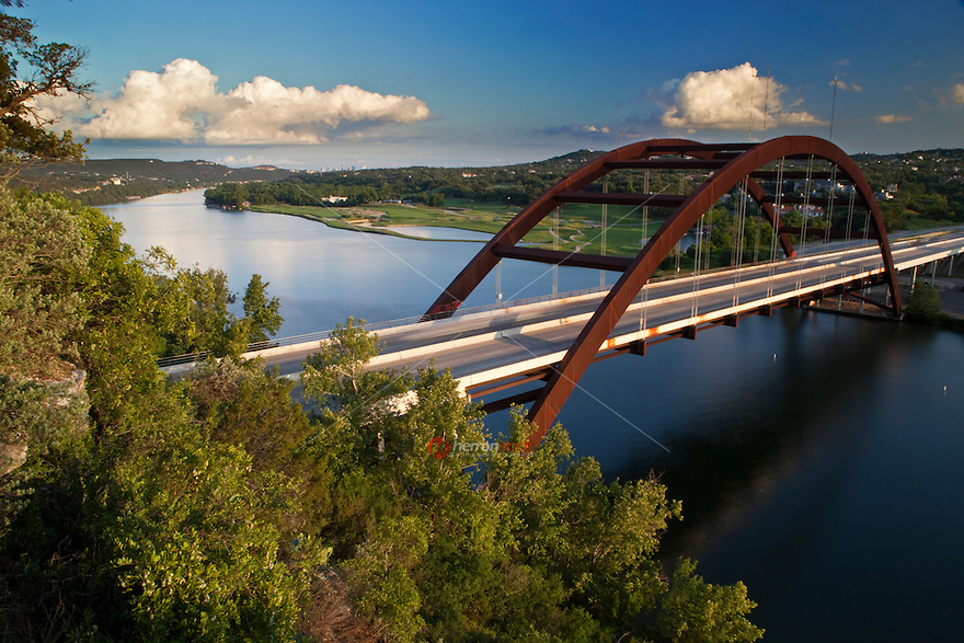 A late afternoon, Austin, Texas view of the Pennybacker Bridge or '360 Bridge' as it is more commonly known. The bridge spans across Lake Austin and connects the Capitol of Texas Highway (Loop 360). You can see downtown Austin off to the left on the horizon.