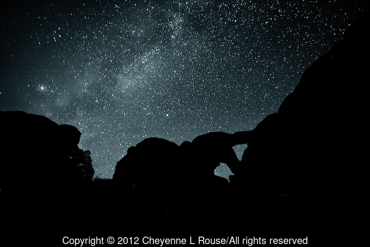 Milky Way Man - Arches NP, Utah. Night time shot of Double Arch with the Milky Way. It looks to me like a man bending over to squeeze out of this world and into the cosmos.
