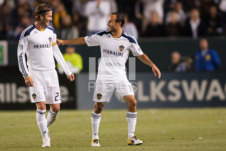 Landon Donovan (10) finishes installing the Captain armband on David Beckham (23) as Donovan exits the pitch late in the match. The LA Galaxy defeated the Portland Timbers 3-0 at Home Depot Center stadium in Carson, California on April 23, 2011....