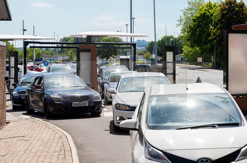 © Licensed to London News Pictures; 02/06/2020; Weston-super-Mare, UK. Vehicles queue at the McDonalds Drivethru at the Queensway Centre in Worle, on its first day of reopening after lockdown during the coronavirus covid-19 pandemic, after the fast food chain announced they were reopening 168 branches across the UK for drive-thru and a further 22 for McDelivery service. Photo credit: Simon Chapman/LNP.