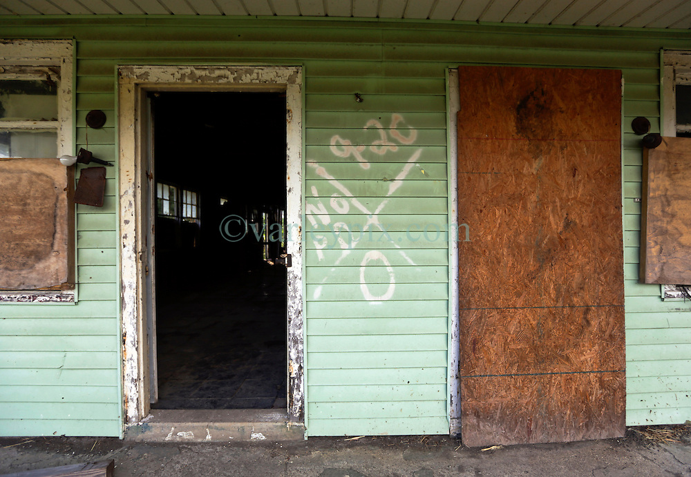 20 August 2015. New Orleans, Louisiana. <br />
Hurricane Katrina revisited. <br />
A decade later and the all too familiar signs of the storm remain on a derelict house in the lower 9th Ward. Recovery remains largely elusive for the area hardest hit by Katrina.<br />
Photo credit©; Charlie Varley/varleypix.com.