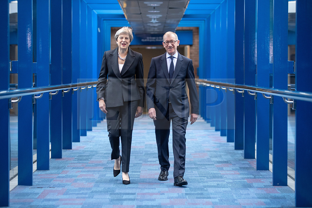 © Licensed to London News Pictures . 03/10/2018. Birmingham, UK. Prime Minister THERESA MAY and her husband PHILIP MAY cross the bridge from the Hyatt Regency Hotel to the Conference Centre ahead of the Leaders' speech . Day 4 of the Conservative Party conference at the ICC in Birmingham . Photo credit: Joel Goodman/LNP