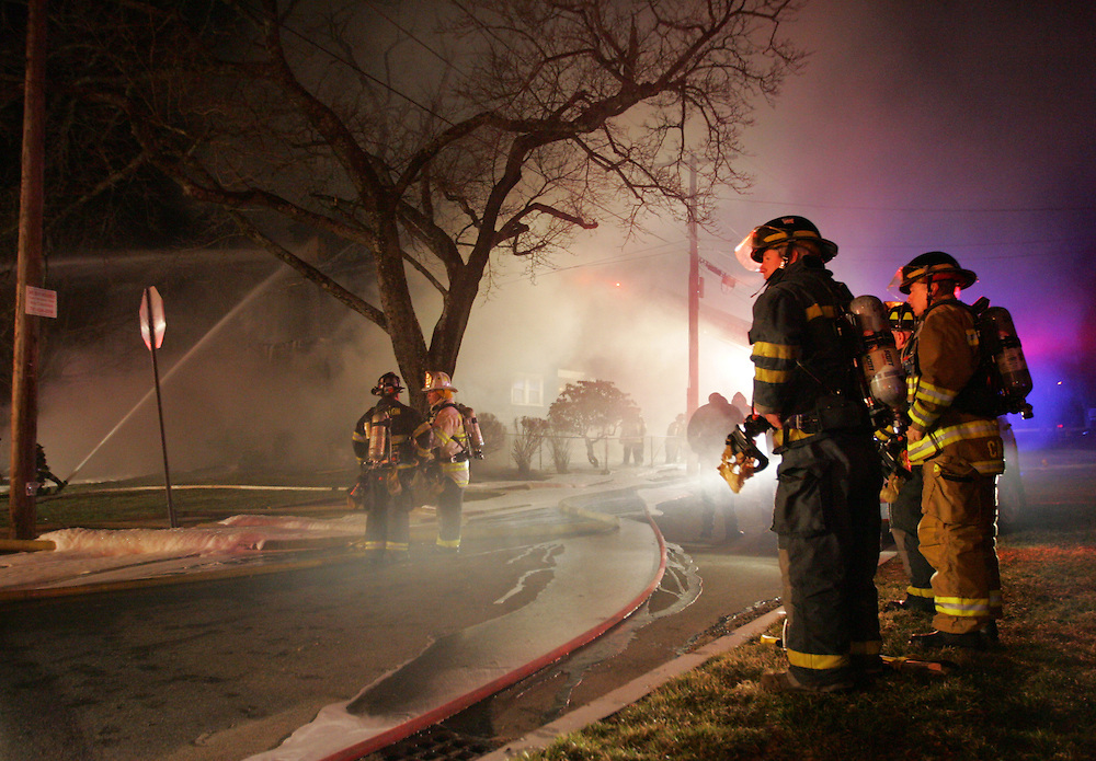Westwood, MA 03/31/2011.Firefighters from Westwood and surrounding towns work to control a house fire on Washington St. at Dean early Thursday morning. The 3 alarm fire started on the front porch and quickly spread through all three floors and the roof, officials said..Alex Jones / www.alexjonesphoto.com