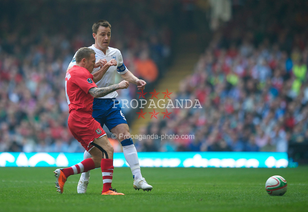 CARDIFF, WALES - Saturday, March 26, 2011: England's captain John Terry and Wales' Craig Bellamy during the UEFA Euro 2012 qualifying Group G match at the Millennium Stadium. (Photo by Chris Brunskill/Propaganda)