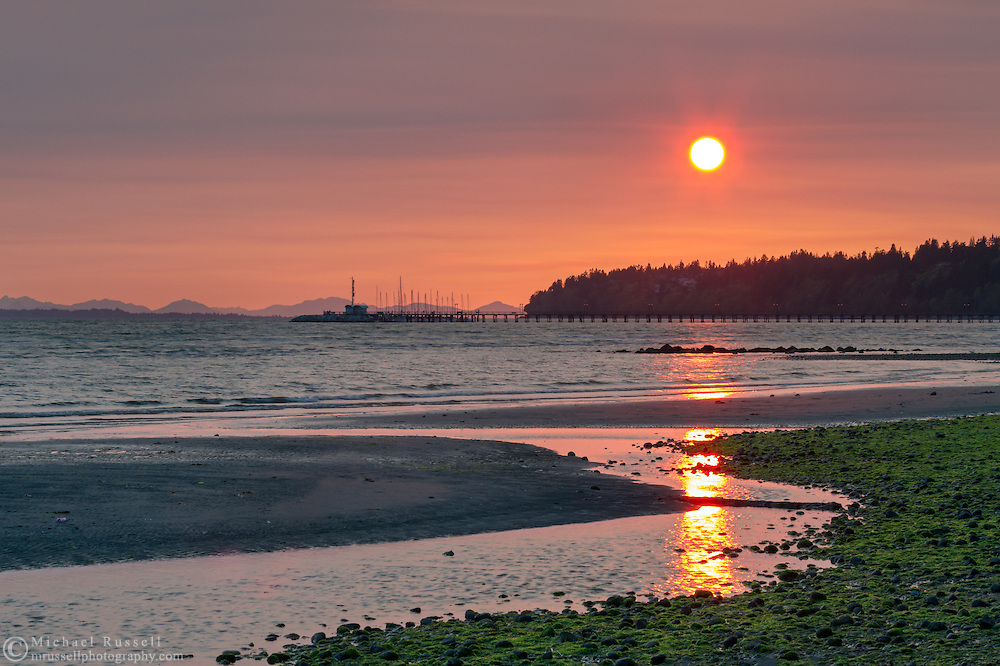 Sunset from the East Beach in White Rock, British Columbia, Canada. Air pollution or smoke from a recent fire in Squamish account for the atmospheric conditions.