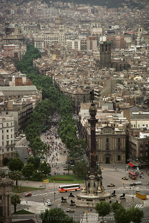 Aerial of Las Ramblas, a tree-lined street, that runs through the heart of the Gothic Quarter, starting at the port's monument to Christopher Columbus. Barcelona, Spain.