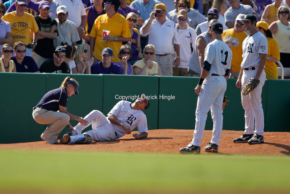 06 June 2009: A trainer tends to injured third baseman Anthony Rendon (23) in the top of the second inning, during game two of the NCAA baseball Super Regional between the Rice Owls and the LSU Tigers at Alex Box Stadium in Baton Rouge, Louisiana.
