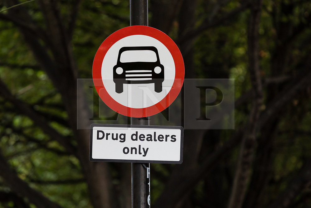 © Licensed to London News Pictures. 16/09/2018. London, UK. Community activists erect hoax street signs in residential streets near Columbia Road, east London this morning to highlight the high levels of drug dealing, where the cheapest heroin in Europe can allegedly be purchased. The anti drugs street art campaign called the 'Columbia Road Cartel' has been commissioned by the Weavers Community Action Group in Shoreditch, Tower Hamlets. Photo credit: Vickie Flores/LNP