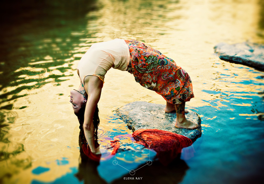 Yoga Woman outdoors in yoga pose urdhva dhanurasana in a colorful pond.<br />
:::<br />
"All fluid activities are in resonance. They mutualize and inform each other. The fluid inside this biosphere called Earth and the fluids of our bodies are in constant rapport."<br />
—Emilie Conrad