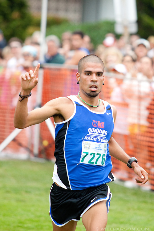 Sergio Gonzalez from Oceanside crosses the finish line in first place with a time of 1:09:48 during the La Jolla Half Marathon, April 25, 2010.