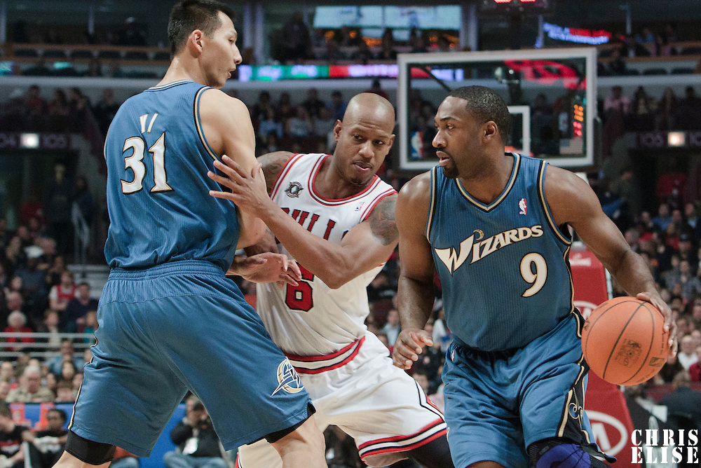 13 November 2010: Washington Wizards' point guard #9 Gilbert Arenas drives past Chicago Bulls' shooting guard #6 Keith Bogans on a screen by Washington Wizards' power forward #31 Yi Jianlian during the Chicago Bulls 103-96 victory over the Washington Wizards at the United Center, in Chicago, Illinois, USA.