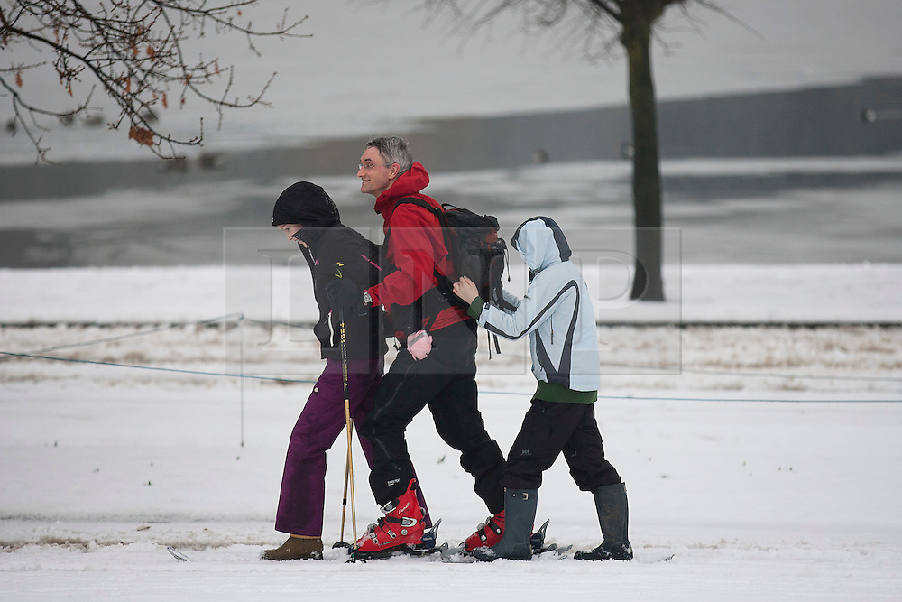© Licensed to London News Pictures. 05/02/2012. LONDON, UK. Two children hitch a lift with their father as he skis through a snowy Hyde Park in London today (05/02/12). Millions of Britons woke up to a snowy Sunday after heavy snow fall covered much of the UK. Photo credit: Matt Cetti-Roberts/LNP