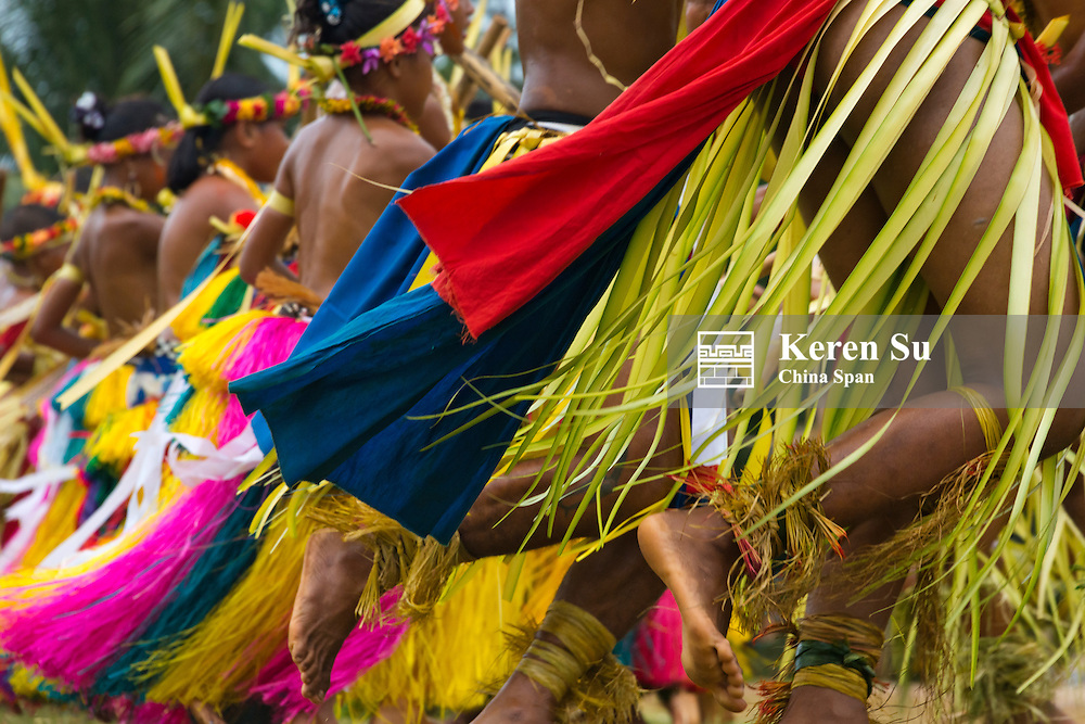Yapese boys and girls in traditional clothing dancing with bamboo pole at Yap Day Festival, Yap Island, Federated States of Micronesia