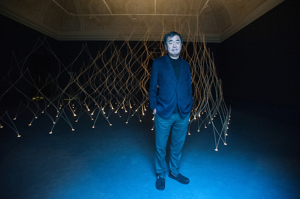 London, UK - 21 January 2014: architect Kengo Kuma poses next to their installation at the Sensing Spaces: Architecture Reimagined exhibition at the Royal Academy of Arts