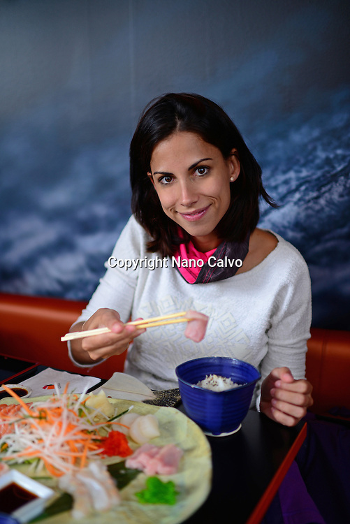 Young woman eating at Etika, Japanese restaurant in Tórshavn, Faroe Islands