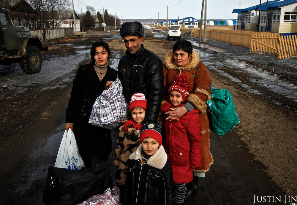 Patvakan Akobian, 33, his wife Satenik Kasarian, 28, with their three children and his mother arrive from Armenia to make their new home in Ushakovo in Russia. Ushakovo, on the Russian side of the border with China, is a development zone where Russia wants to attract Russian-speaking migrants to populate its sparse Far East. Migrants from the former Soviet block are given housing, cattle and a barn to help them start their new life in the Amurskaya Region.