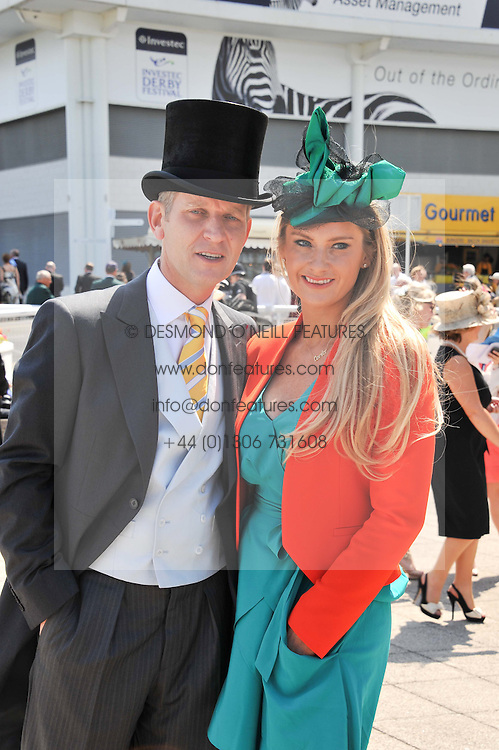 JEREMY KYLE and his wife CARLA at the Investec Derby at Epsom Racecourse, Epsom Downs, Surrey on 4th June 2011.